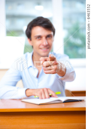 Businessman sitting indoors and writing plan in his diary Businessman sitting indoors and writing plan in his diary 6463552