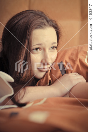 Closeup portrait of young pretty girl laying on her bed Closeup portrait of young pretty girl laying on her bed 6463847