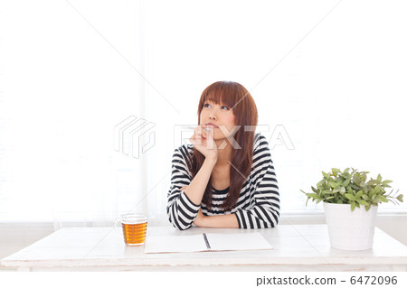 A woman holding a household account book 6472096
