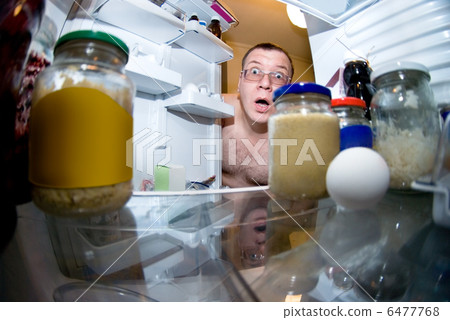 surprised man looks into fridge surprised man looks into fridge 6477768