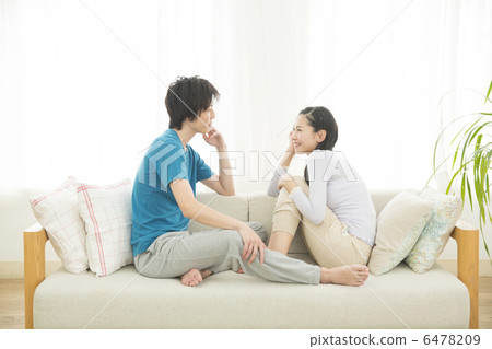 A young couple relaxing on the sofa 6478209