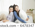 Two young women relaxing at bed 6478347