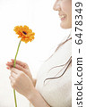 A young woman with flowers 6478349