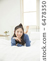 A young woman relaxing at bed 6478350