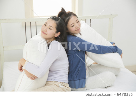 Two young women relaxing at bed Two young women relaxing at bed 6478355