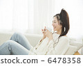 Young woman relaxing on a sofa 6478358