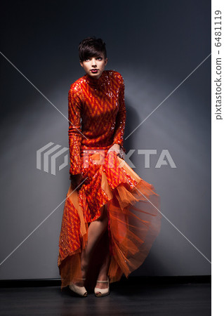 Trendy Brunette posing in Red Dress. Studio Shot Trendy Brunette posing in Red Dress. Studio Shot 6481119