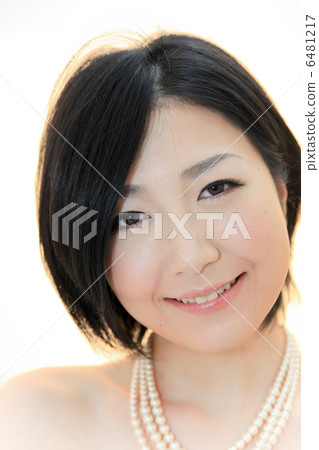 微笑：珍珠項鍊（背光）與裸露皮膚的美麗年輕女性 6481217