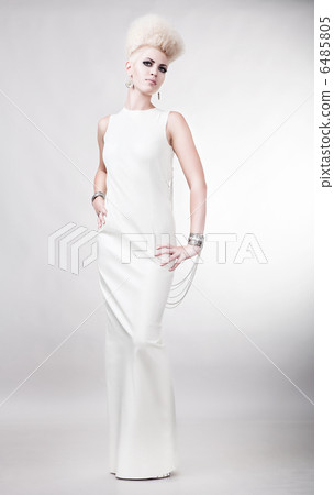 blond attractive woman in white dress with creative hairstyle 6485805