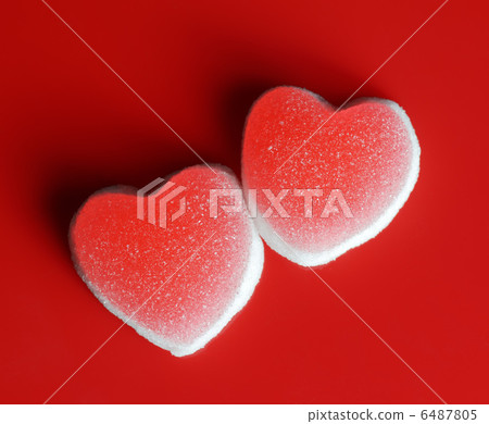 Sugar hearts on red background 6487805