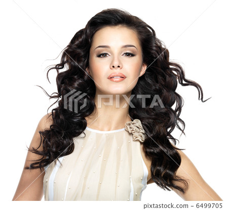 Beautiful brunette woman with beauty long curly hair. 6499705