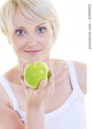 happy young woman eat green apple isolated on white happy young woman eat green apple isolated on white 6499993