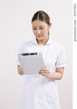 A lady in a white garment with a tablet terminal 6507881