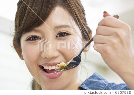 A woman who is cooking on a fork A woman who is cooking on a fork 6507988