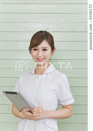 A lady in a white garment with a tablet terminal 6508172