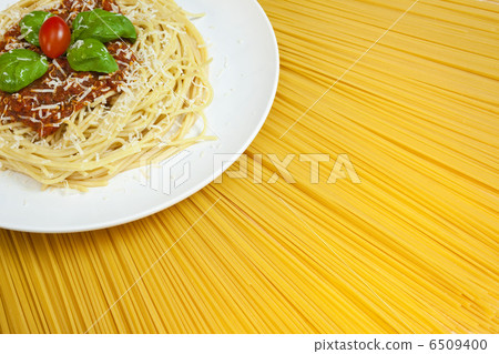Plate of Spaghetti Bolognese on A Sunny Display of Dried Pasta 6509400