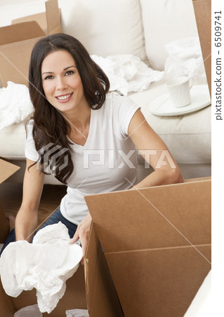 Single Woman Unpacking Boxes Moving House 6509741