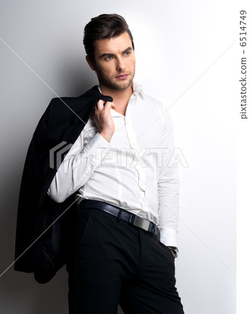 Fashion young man in white shirt holds the black jacket - Stock Image -  Everypixel