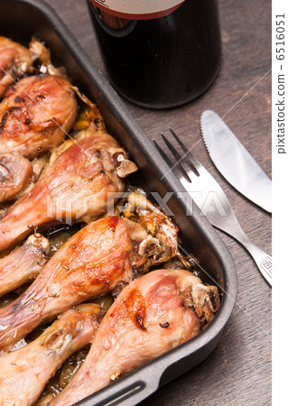 baked chicken legs in tray on black wooden 6516051