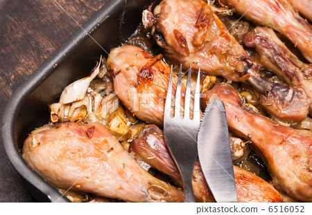 baked chicken legs in tray on black wooden 6516052