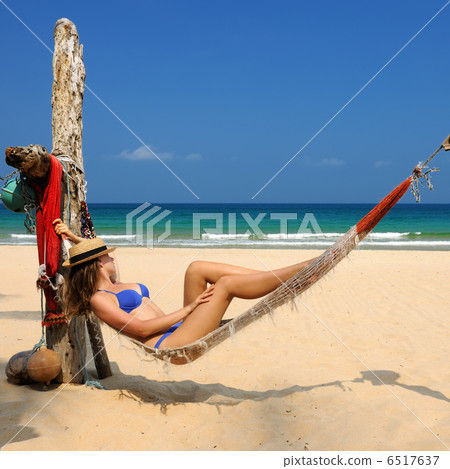 Woman in hammock on beach Woman in hammock on beach 6517637