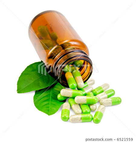 圖庫照片: capsules green in an open jar with leaf