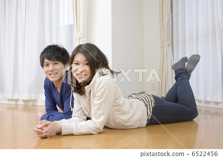 A young couple lying in the living room of the new house A young couple lying in the living room of the new house 6522456