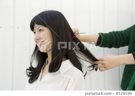 A woman cutting her hair 6528590