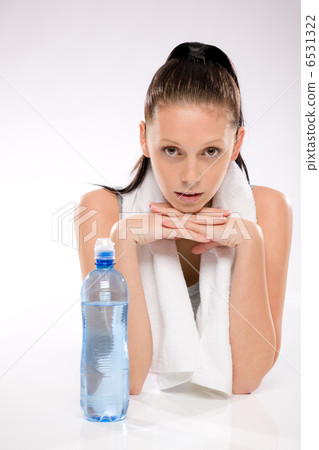 Young woman lying with chin on hands Young woman lying with chin on hands 6531322