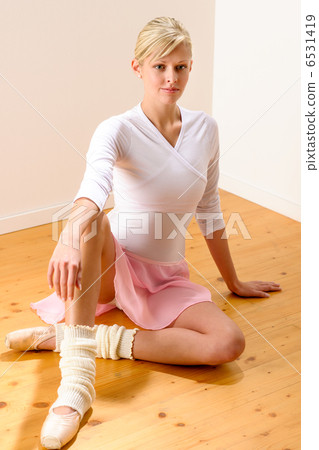 Ballet dancer sitting on the studio floor Ballet dancer sitting on the studio floor 6531419
