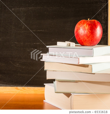 Professors academic table pile of books 6531618
