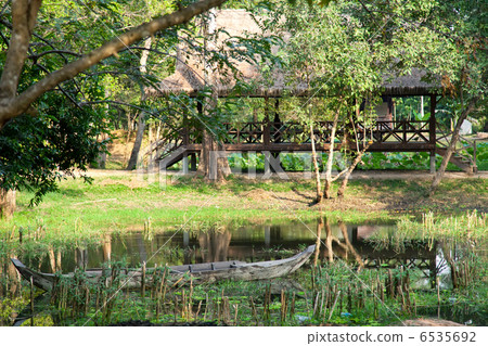 Wooden boat on the lake in asian forest Wooden boat on the lake in asian forest 6535692