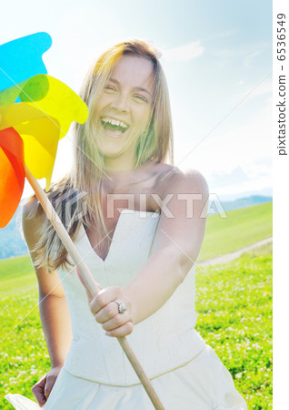 beautiful bride outdoor with colorful windmill toy beautiful bride outdoor with colorful windmill toy 6536549
