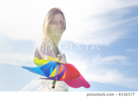 beautiful bride outdoor with colorful windmill toy beautiful bride outdoor with colorful windmill toy 6536577