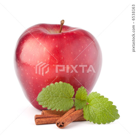 Red apple, cinnamon sticks and mint leaves still life 6538163