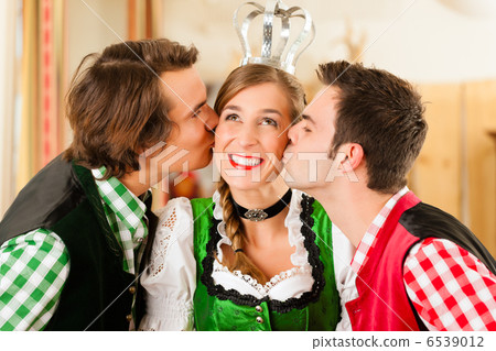 Young people in traditional Bavarian Tracht in restaurant or pub Young people in traditional Bavarian Tracht in restaurant or pub 6539012