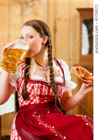 Young woman in traditional Bavarian Tracht in restaurant or pub Young woman in traditional Bavarian Tracht in restaurant or pub 6539021