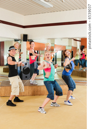 Zumba or Jazzdance - young people dancing in studio 6539037