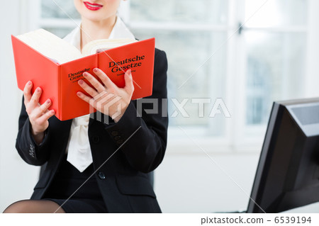 Lawyer in office reading law book Lawyer in office reading law book 6539194