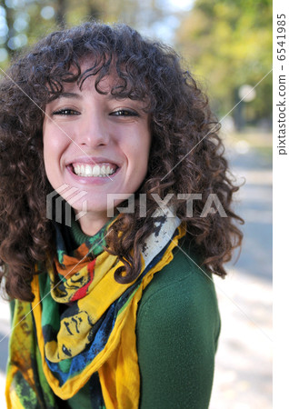 Young curly woman smiling 6541985