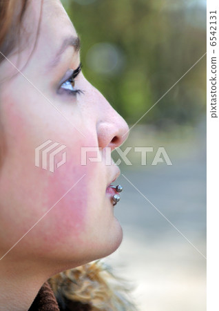 brunette Cute young woman with piercing posing outdoors 6542131