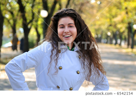 brunette Cute young woman smiling outdoors in nature brunette Cute young woman smiling outdoors in nature 6542154