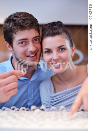 happy young couple in jewelry store 6542716