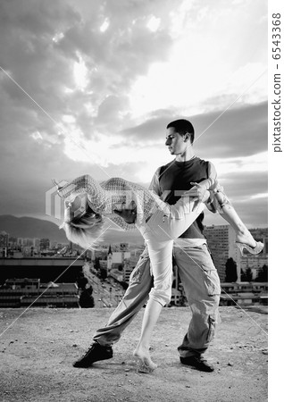 romantic urban couple dancing on top of bulding 6543368