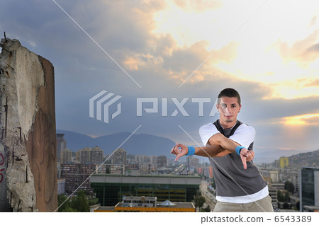 young man jumping in air outdoor at night ready to party 6543389