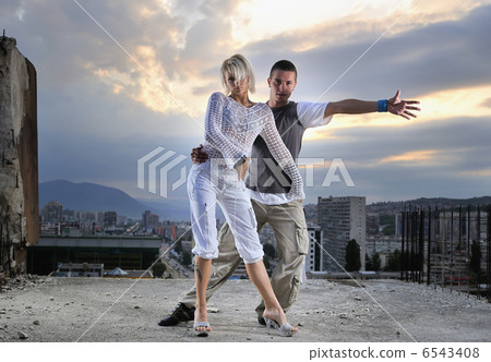 romantic urban couple dancing on top of bulding romantic urban couple dancing on top of bulding 6543408