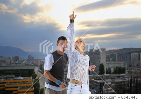romantic urban couple dancing on top of bulding romantic urban couple dancing on top of bulding 6543445