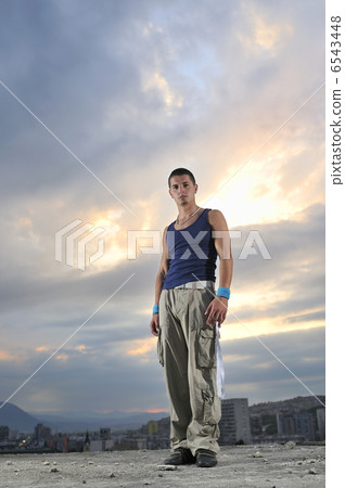 young man dancing and jumping on top of the building 6543448