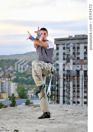 young man jumping in air outdoor at night ready to party young man jumping in air outdoor at night ready to party 6543472