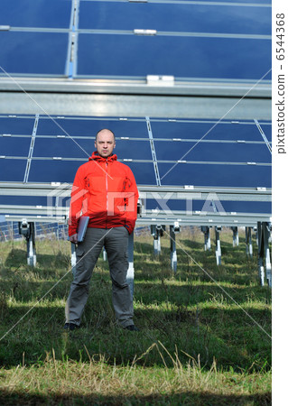 engineer using laptop at solar panels plant field engineer using laptop at solar panels plant field 6544368